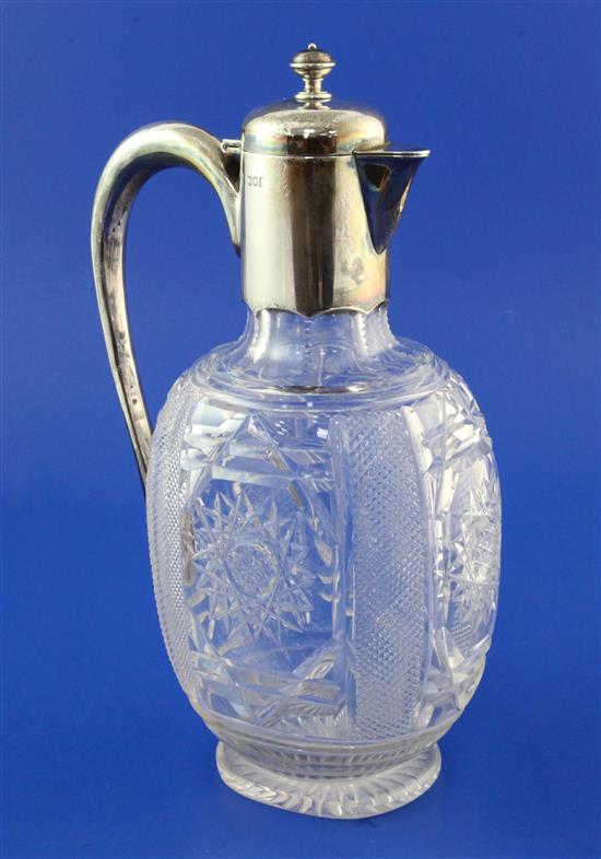 An Edwardian silver mounted cut glass claret jug by Goldsmiths & Silversmiths Co Ltd, 10.75in.